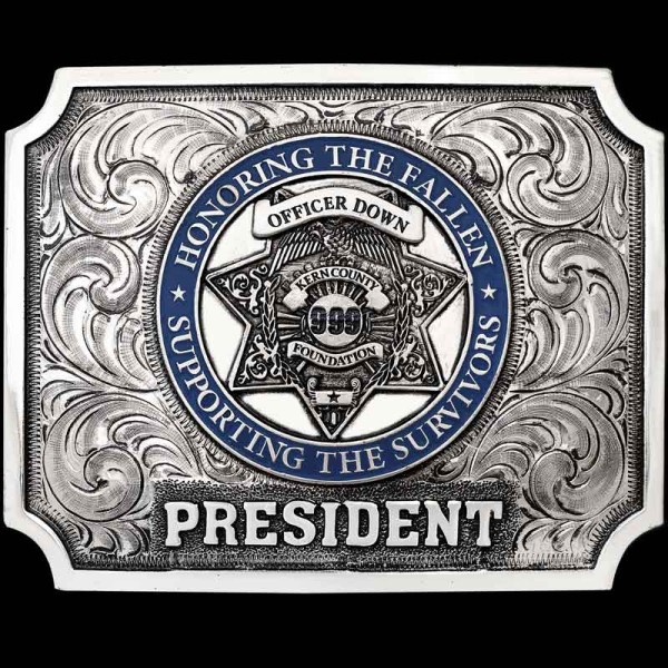 "Let's hear it for the Boys in Blue. Our Bakersfield Buckle is crafted on a hand-engraved, German Silver base with our signature antiqe finish. The design is simple, yet elegant, with a straight edge, scalloped corners and large German Silver letteri